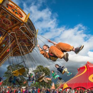 looking up at a man on a spinning carousel