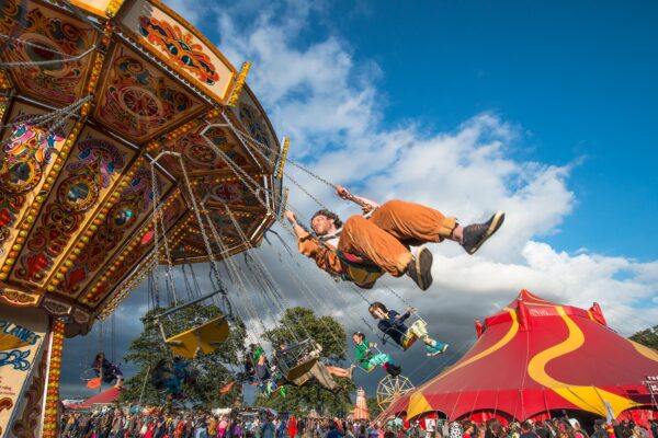 looking up at a man on a spinning carousel