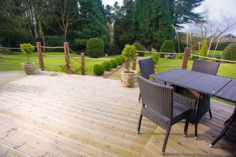 Garden furniture on decking looking out over garden